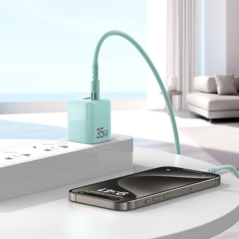 Smartphone charging with a flexible Awei Pakistan USB cable on a modern desk.